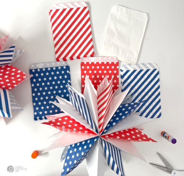 Red, white and blue patriotic paper bags with a completed paper star.