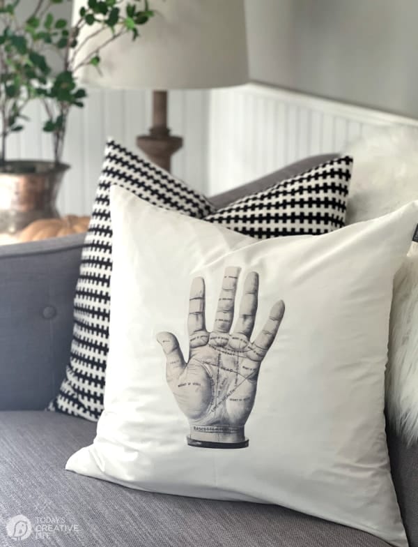 White halloween pillow with palm reading map.