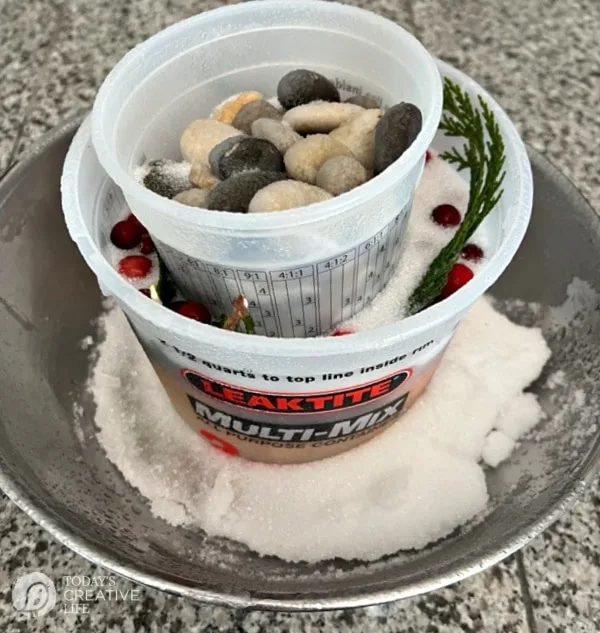 Making an Ice Mold wine chiller. 2 buckets nesting inside of each other. Bucket filled with rocks to weigh it down.