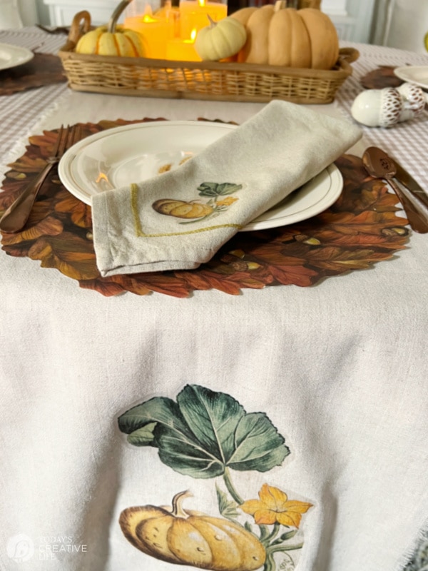 Fall DIY Decor Projects - Dining room table runner and napkin with iron-on pumpkin design.