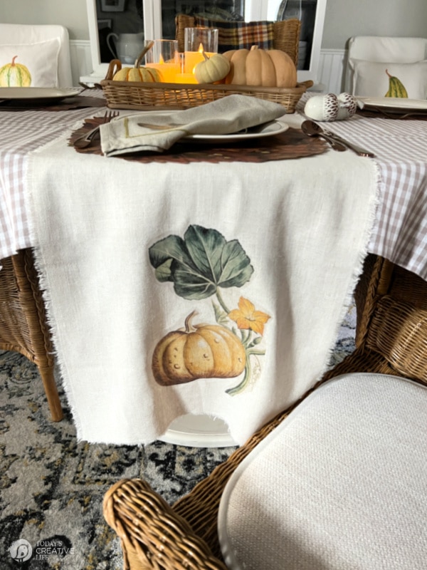 Table runner on table that has pumpkin decoration ironed on. Fall DIY Decor for Thanksgiving. 