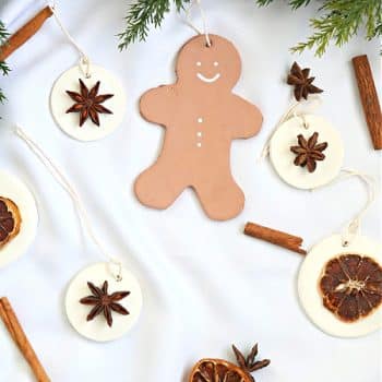 gingerbread man clay ornaments and round white clay ornaments with star anise seeds.