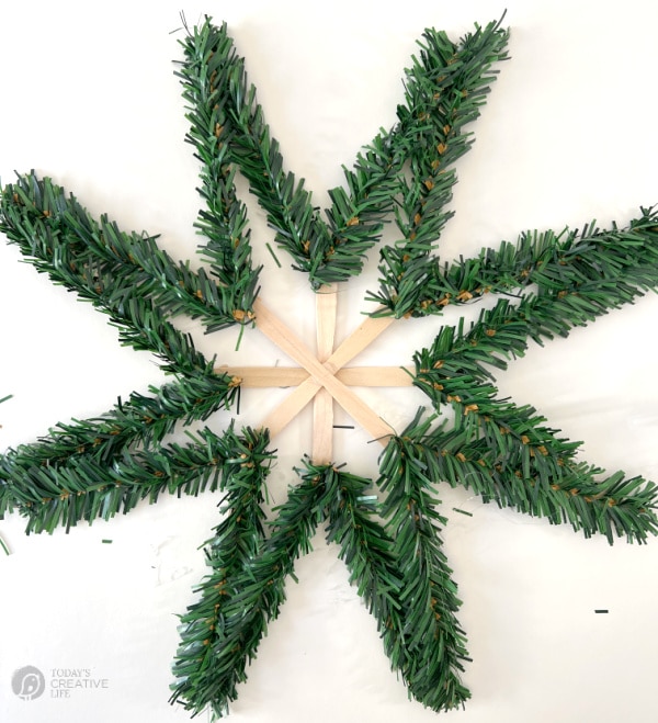 DIY Scandinavian Evergreen Star with middle of the star waiting for the garland ties to be glued in.