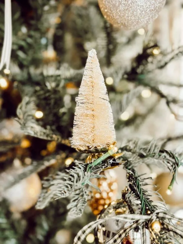 cream colored bottle brush tree decorated for Christmas.