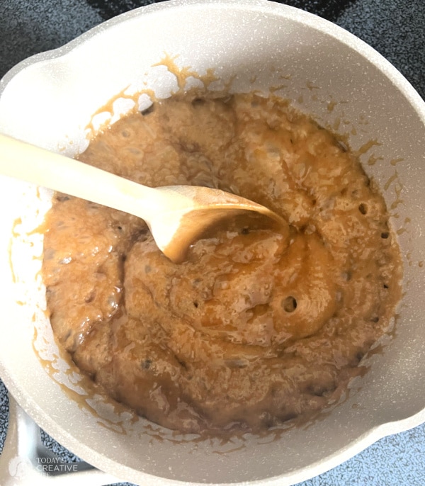 Making toffee in a cream colored sauce pan