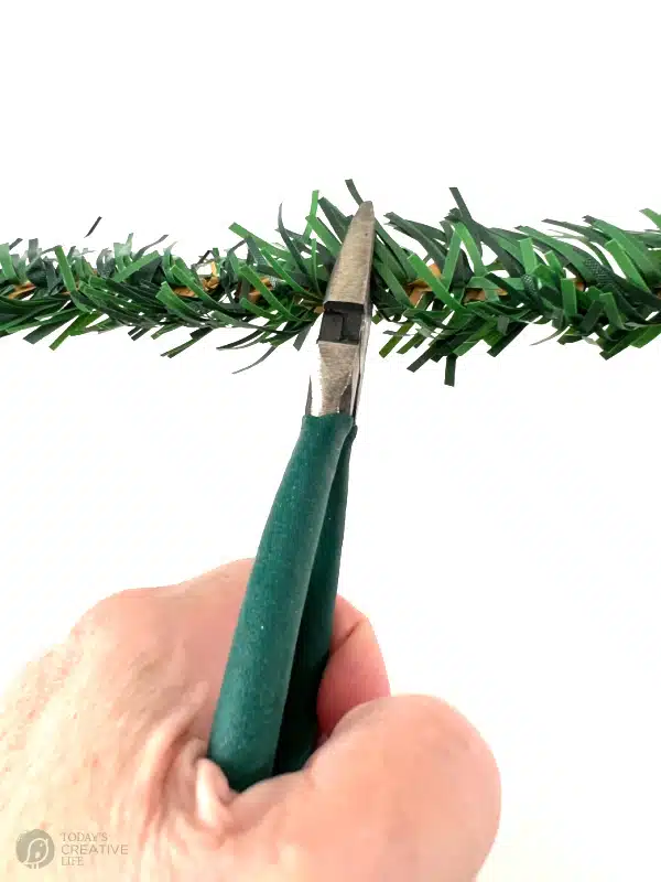 Wire cutters cutting garland ties.