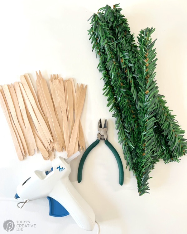 DIY Scandinavian Evergreen Star Supplies. Popsicle sticks, wire cutter, garland ties and a glue gun