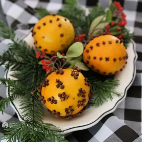 three oranges with cloves. Orange pomanders.