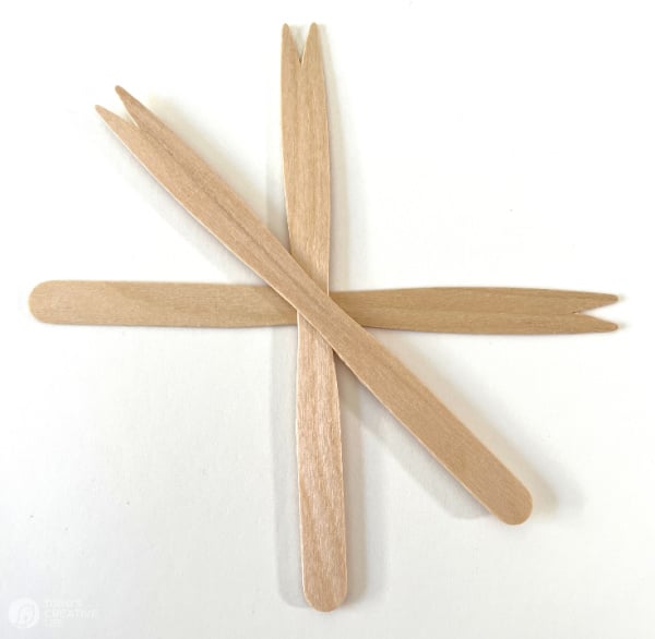 Arranging popsicle sticks for making a Swedish star.