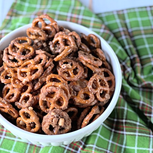 Butter Toffee Pretzels recipe in white bowl with green plaid dish towel