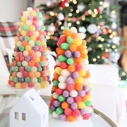 two gumdrop trees on a table in front of a Christmas tree
