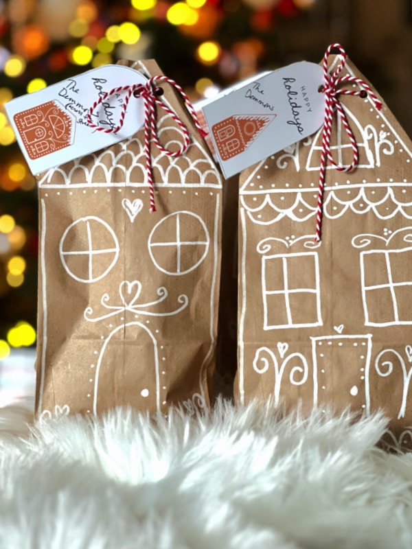 Brown bags made into gingerbread houses with free printable gift tags for Christmas. 