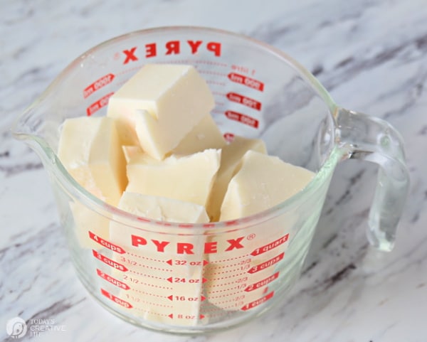 White chocolate chunks in a clear pyrex measuring cup.