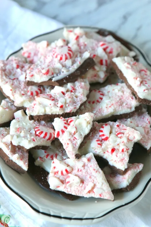 Recipe for peppermint bark - candy bark broken into pieces on a plate. 