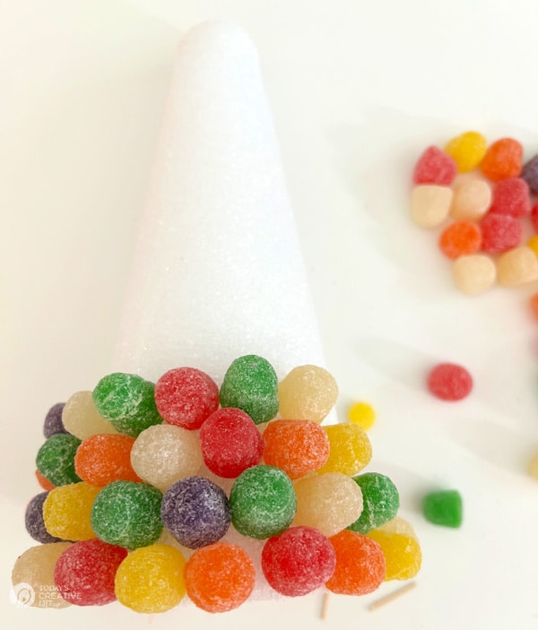 colorful gumdrops stuck into a white styrofoam cone.
