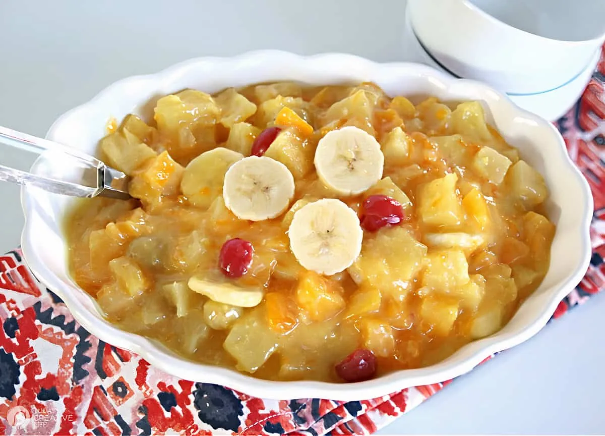 White bowl filled with vanilla pudding fruit cocktail salad