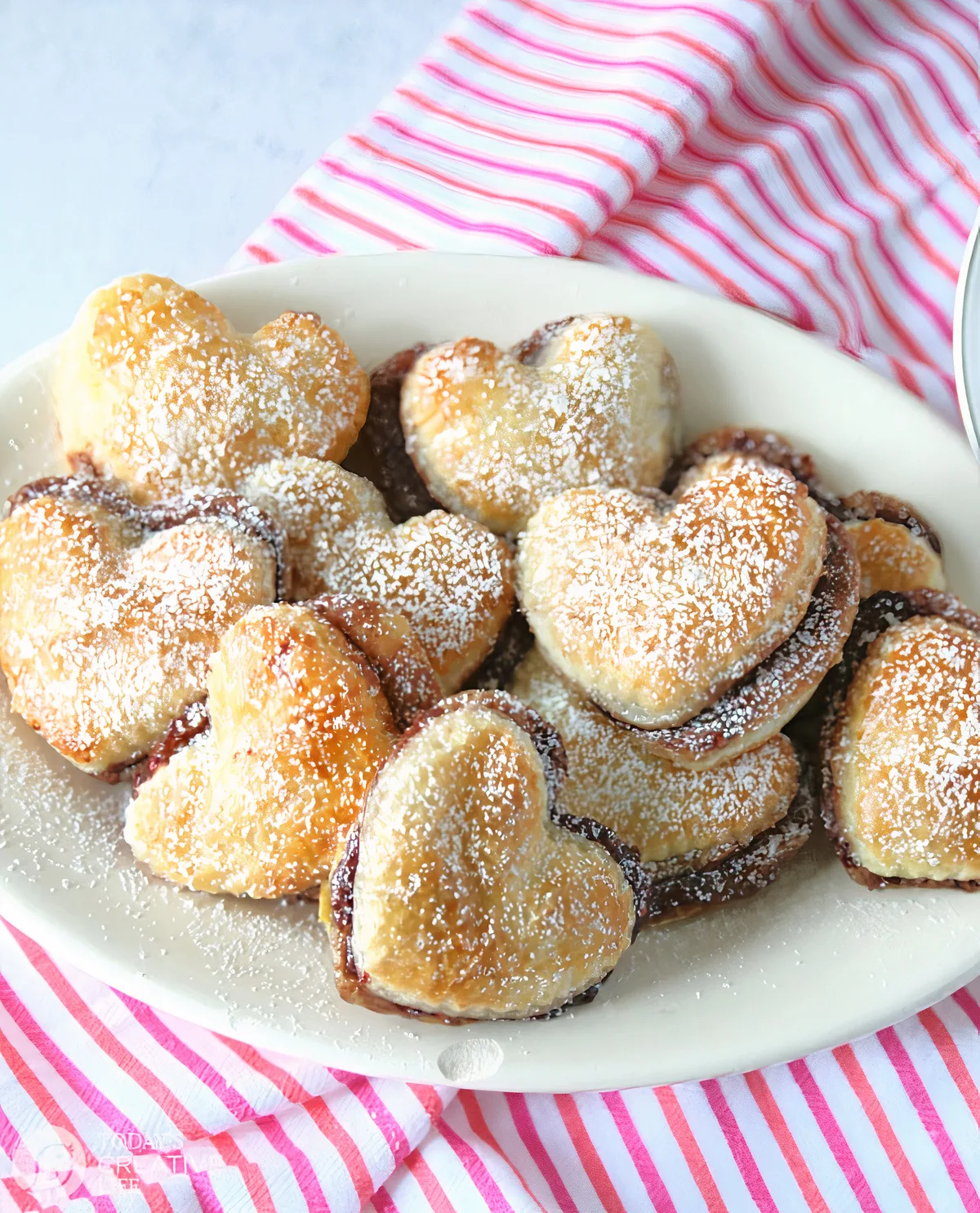 Plate filled with heart shaped puff pastry treats